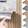 Close-up of a self-adhesive wood grain wall panel being applied to a surface, showing the texture and installation process.