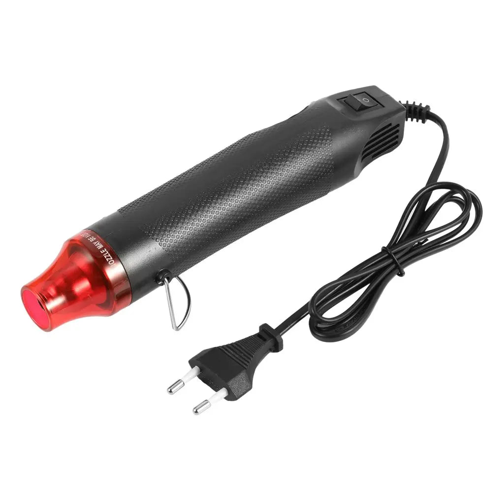A black electric heat gun with a red tip and a coiled cord is shown against a white background.