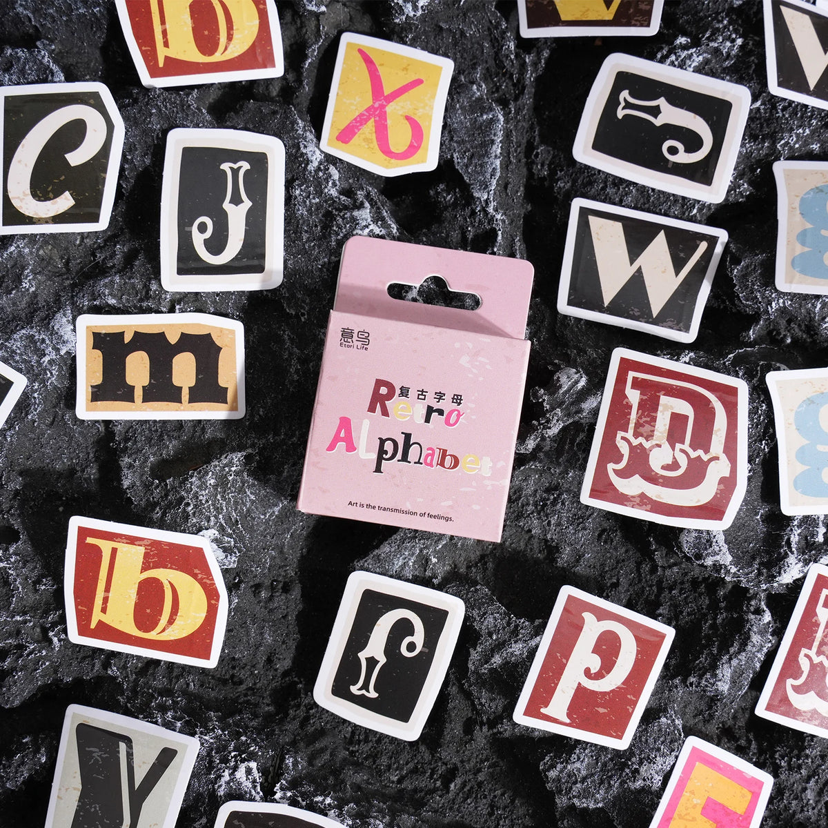A collection of vintage alphabet stickers featuring various letters and symbols on a dark background.