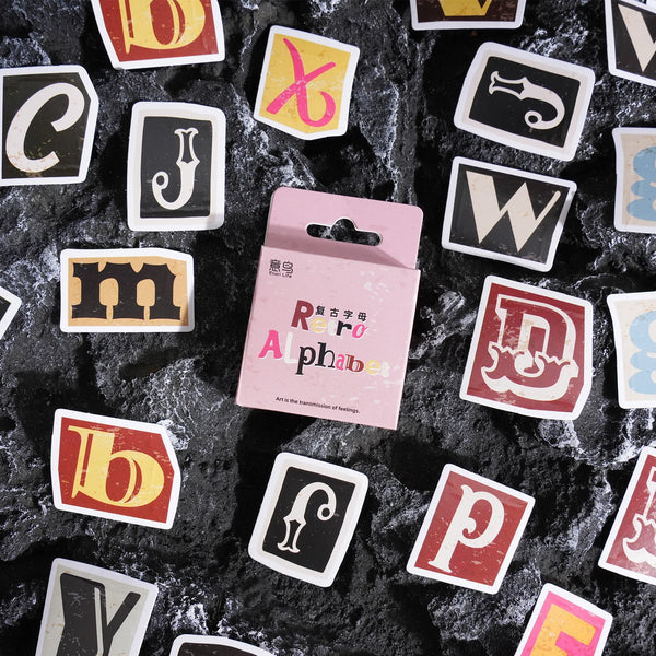 A collection of vintage alphabet stickers featuring various letters and symbols on a dark background.