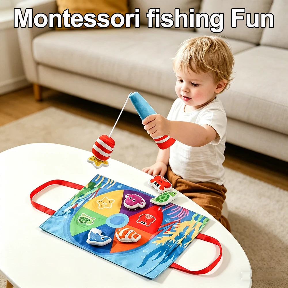 A toddler is playing a Montessori fishing game with a string and a colorful plastic fish on a white table.
