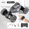 A grey remote control watch is shown with various modes and accessories for a stunt car vehicle.