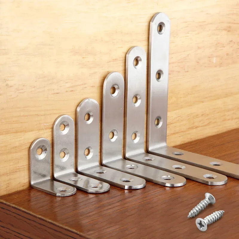 A set of four stainless steel 90-degree angle brackets with screws arranged in a diagonal line on a wooden surface.