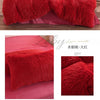 A set of plush red mink velvet duvet covers and sheets displayed on a bed.