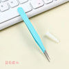 A light blue precision craft tool with straight tips is shown resting on a white keyboard.