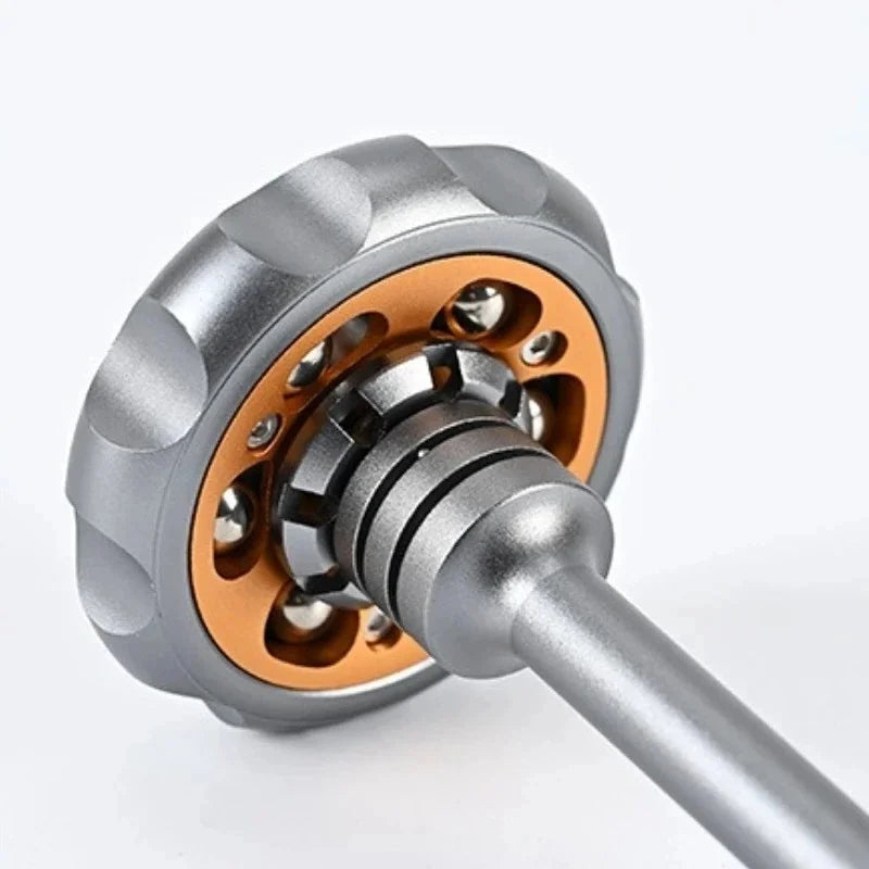 A close-up view of a metal fidget toy with a silver and copper finish, showing the spinning mechanism.