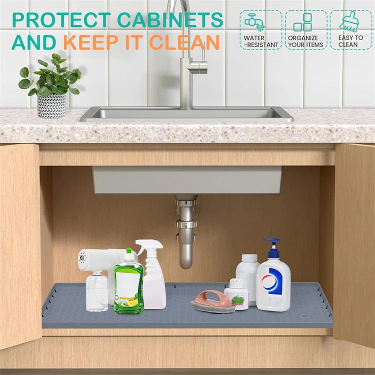 A flexible silicone under-sink mat with a raised edge is shown in a kitchen cabinet, designed to protect cabinets and keep it