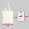 A white canvas shopping tote bag shown next to an A4 sized piece of paper for scale.