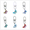 A set of colorful butterfly keychain charms with silver clasps and rings.