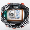 Black and white zebra print duffle bag open showing a camera and other gear inside