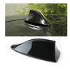A black shark fin car antenna with a clear dome, shown in close-up and full view.
