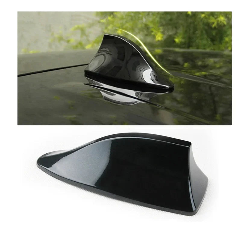 A black shark fin car antenna with a clear dome, shown in close-up and full view.