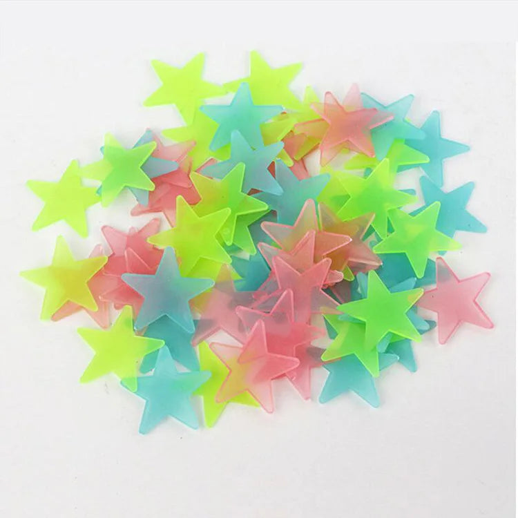 A pile of 100 luminous star-shaped wall stickers in various pastel colors like pink, blue, and green.