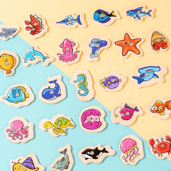 A collection of wooden magnetic fishing game pieces featuring various marine life animals like fish, octopus, and sea creatur