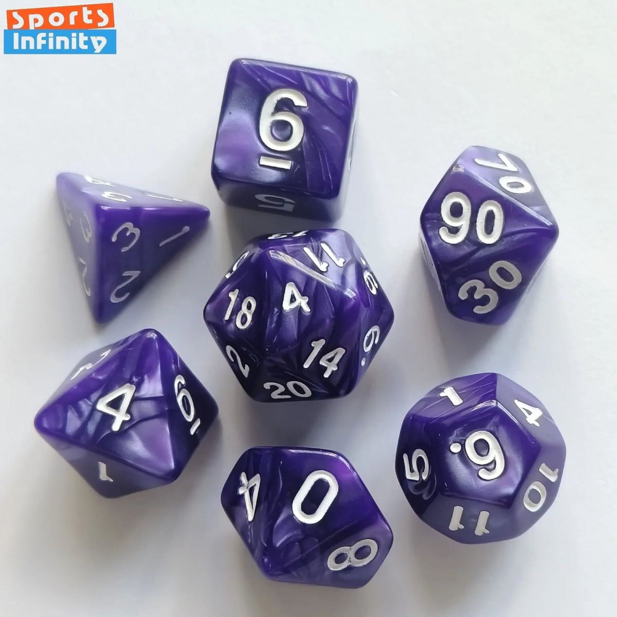 A set of seven purple and white polyhedral dice scattered on a white surface.