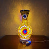 A handcrafted Turkish mosaic table lamp with a warm LED glow, featuring geometric patterns on a glass base.