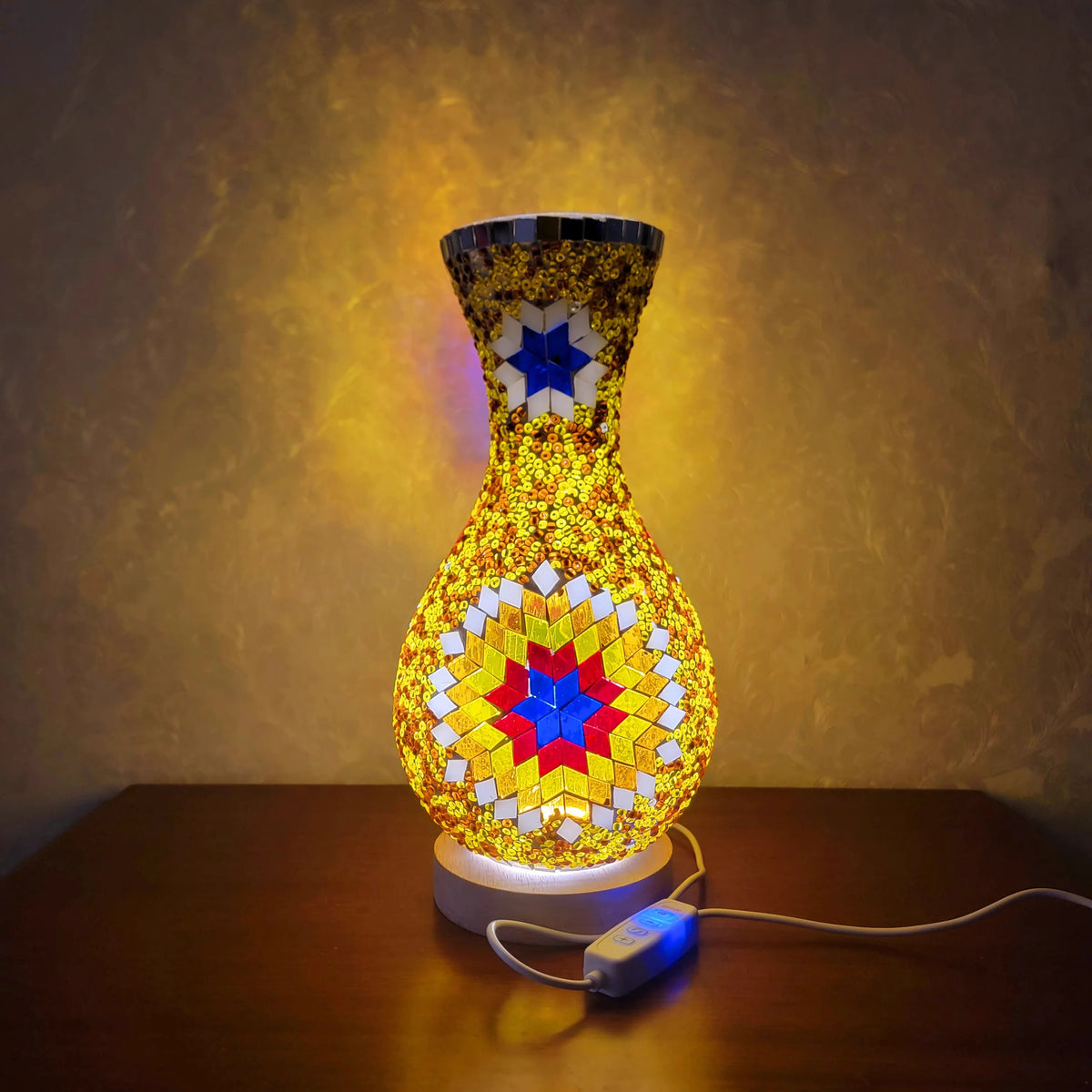 A handcrafted Turkish mosaic table lamp with a warm LED glow, featuring geometric patterns on a glass base.