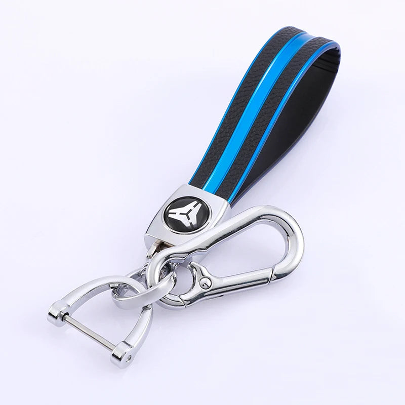 Black and blue TPU leather car key cover with a silver keychain attached.