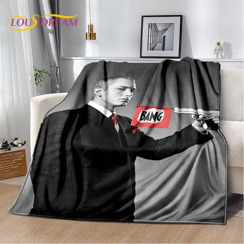 A throw blanket featuring a black and white portrait of Eminem and 2Pac.