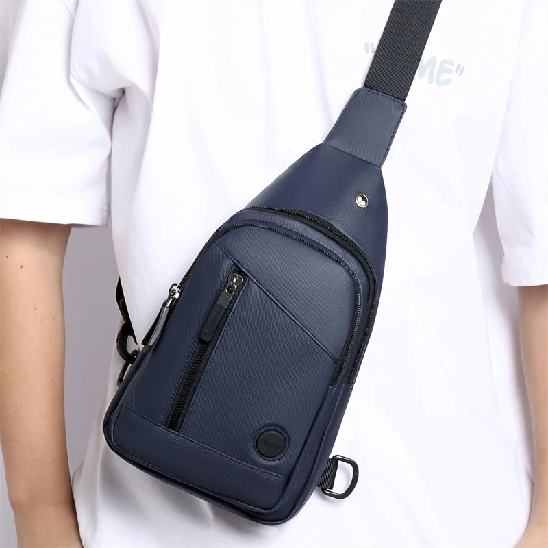 A navy blue men's adjustable crossbody chest bag worn by a person.