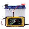A yellow battery charger device with a digital display is shown next to a blue storage container.