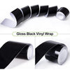 Rolls of gloss black vinyl wrap strip used for automotive and DIY projects