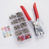 A clear plastic case containing a set of metal snap fasteners and red pliers for pressing them.