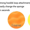 A hand holds an orange sponge attached to a black pad, demonstrating a strong hook and loop attachment for changing sponges i