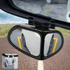 A close-up view of a black blind spot mirror mounted on a car door, showing a reflection of the vehicle and road.