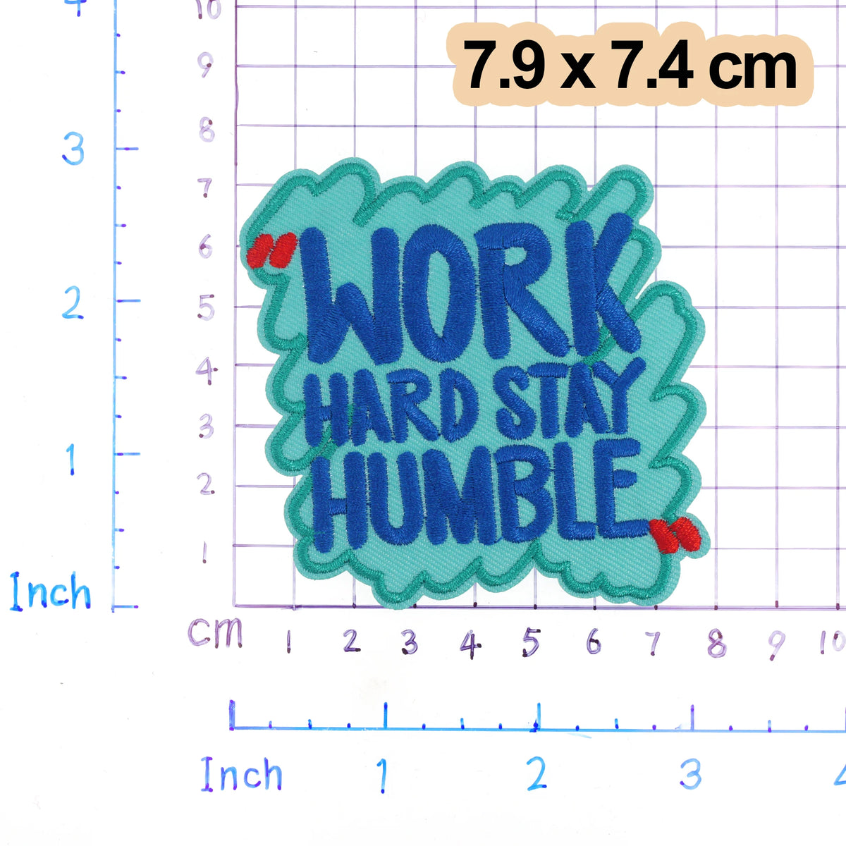 An embroidered patch with the text WORK HARD STAY HUMBLE in blue lettering on a teal background.