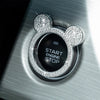 A close-up of a crystal rhinestone ignition button ring featuring a Mickey Mouse design on a silver surface.