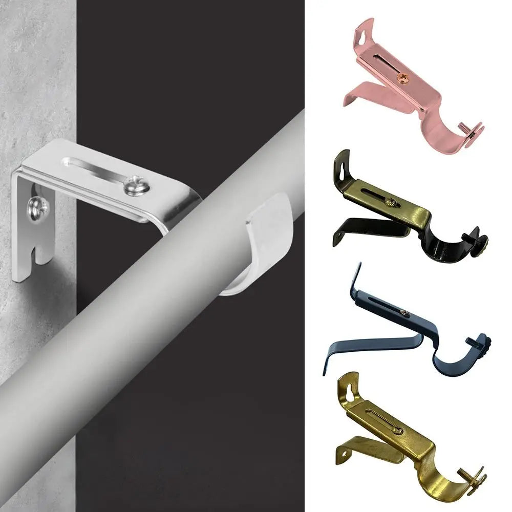 Various metal curtain rod brackets in pink, gold, and blue colors mounted on a white wall.