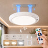 A white motion sensor ceiling light fixture is mounted on a ceiling, with control buttons and light options visible below.