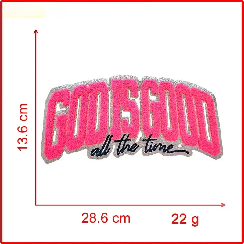 Pink embroidered patch with the text God Is Good all the time on a white background