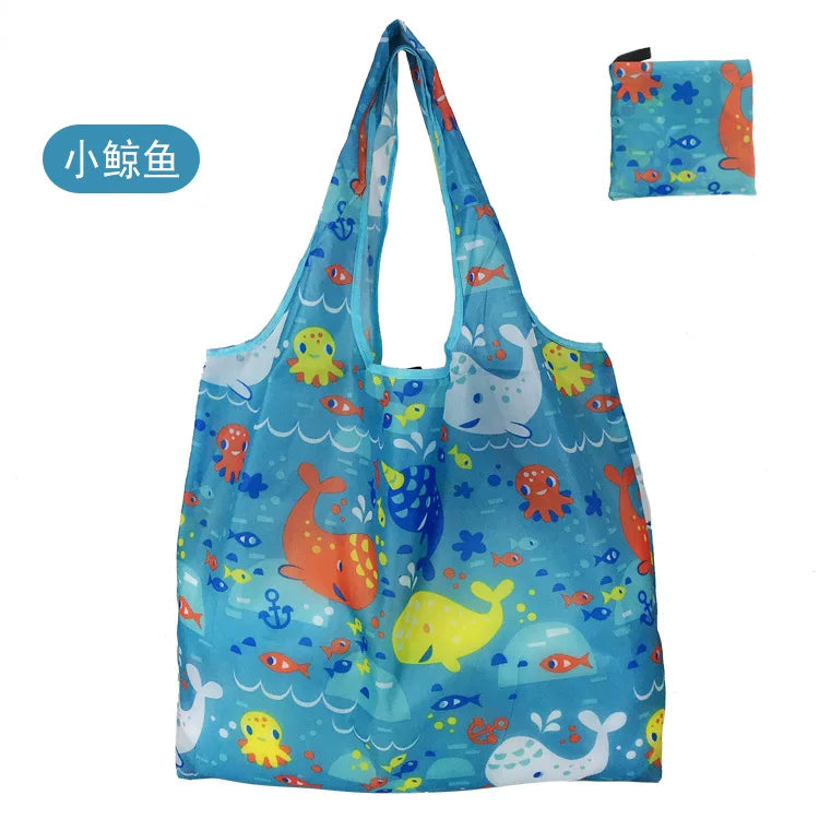 A blue fabric reusable shopping tote bag featuring colorful sea animal patterns.