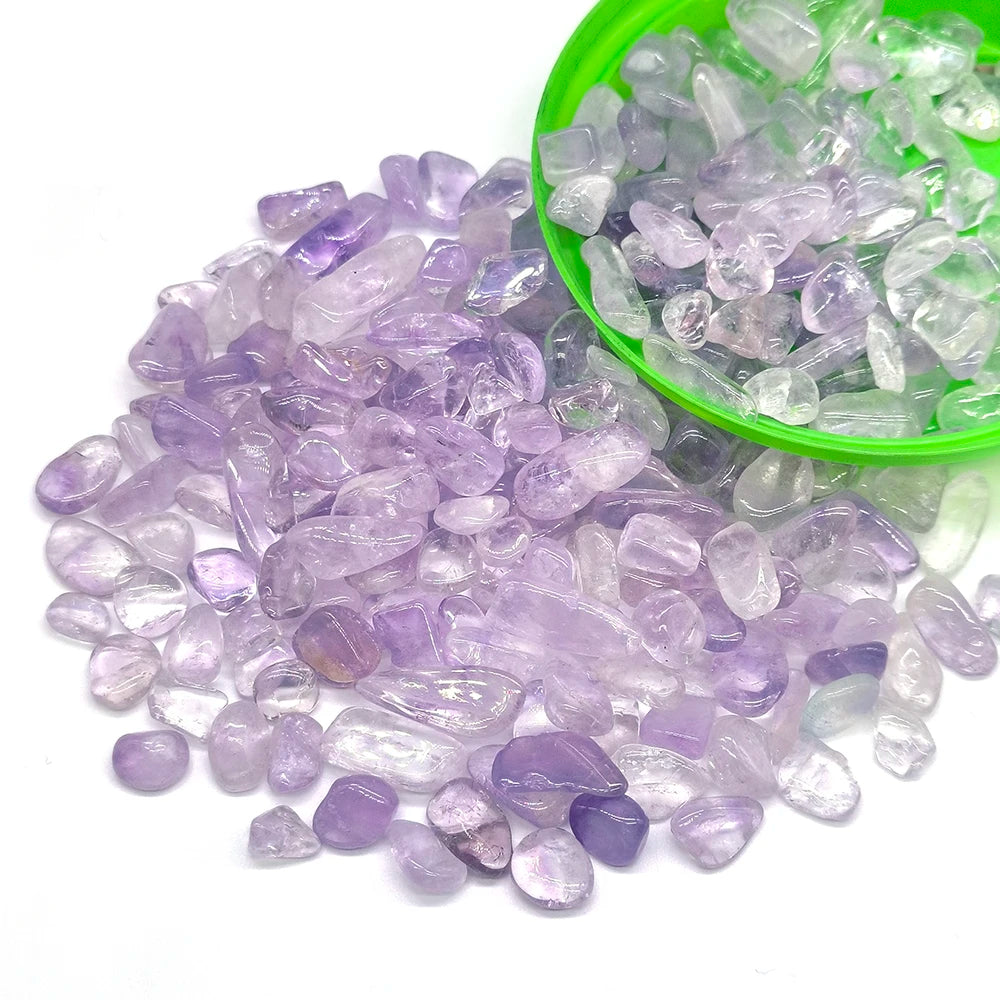 Purple tumbled crystal stone chips in a green bowl