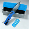 A silver folding pocket knife with a blue handle is displayed inside a blue box.