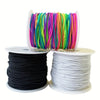 Spools of brightly colored stretchy elastic cord for jewelry making, including rainbow colors and solid black and white.