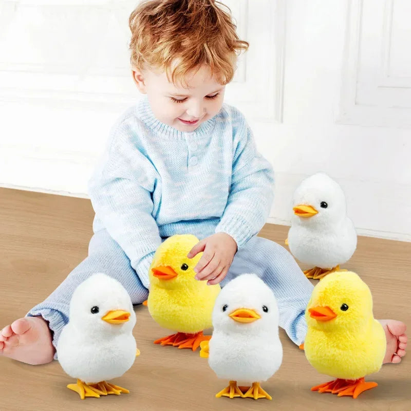 A child is sitting with several yellow and white wind-up walking chicken toys on the floor.