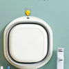 A white fold-down plastic wash basin is shown mounted above a white sink, illustrating daily use space-saving features.