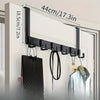 A black over-the-door coat rack with six hooks is shown mounted on a white door, demonstrating its 44cm length.