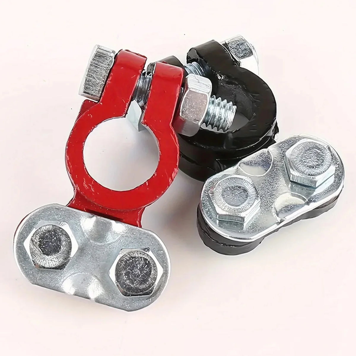 A pair of red and black quick-release car battery terminal connectors with silver hexagonal nuts.