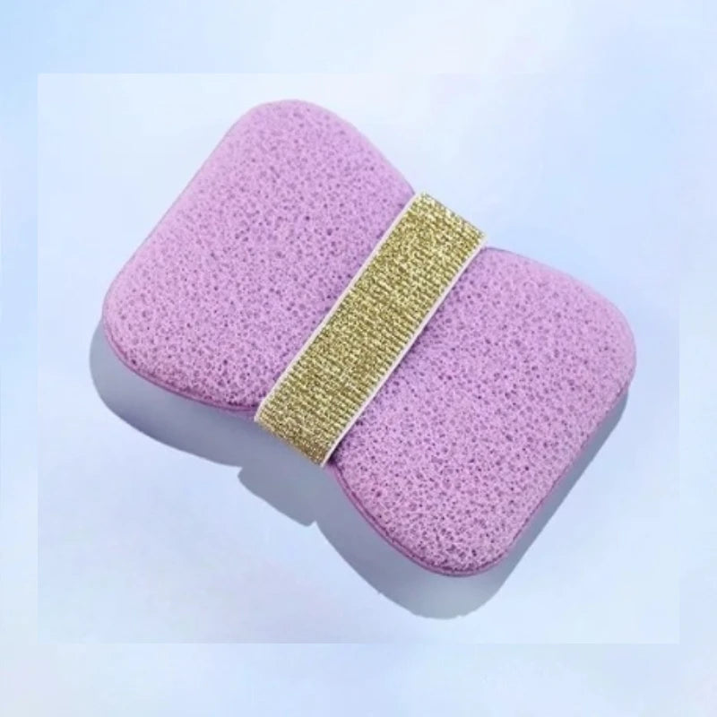 A pink foam soap saver bag with a gold mesh strap is shown against a white background.