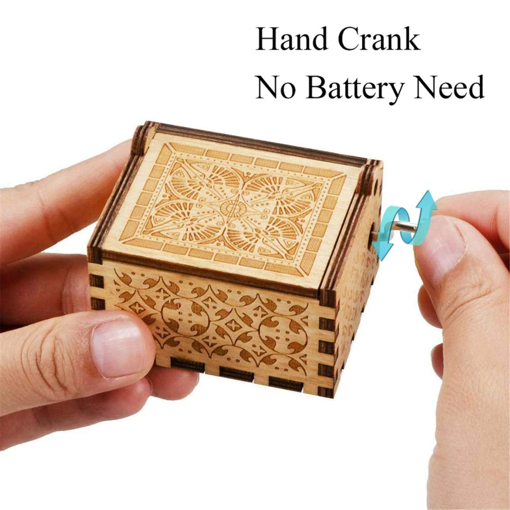 A hand cranked wooden music box made of light wood with intricate patterns.