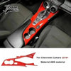 Red interior and exterior trim kit for Chevrolet Camaro featuring a custom shifter and aerodynamic piece.