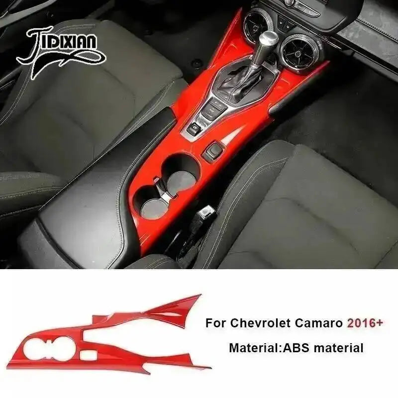 Red interior and exterior trim kit for Chevrolet Camaro featuring a custom shifter and aerodynamic piece.
