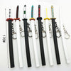 A collection of miniature metal katana replicas featuring various colored hilts and blades.