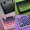 A set of PBT double-shot keycaps featuring gradient colors including green, pink, and purple keycaps.