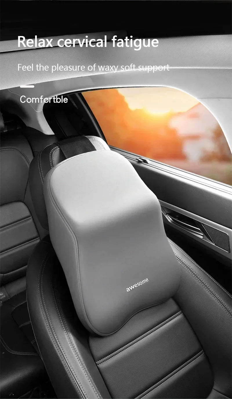 Gray memory foam car headrest and lumbar support pillow installed in a car seat.