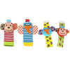 A set of soft baby rattles featuring colorful fabric designs for wrists and feet.